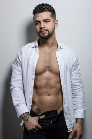 nude male model removing his shirt in preparation for his next hens art class in auckland's point chevalier