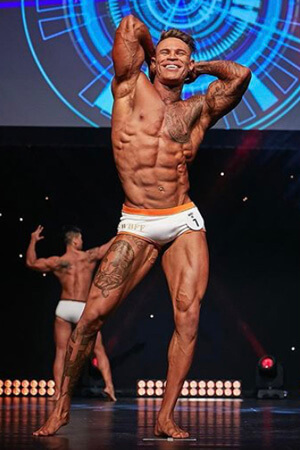 great looking male entertainer stripped down to his undies at an auckland body building competition