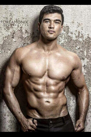 auckland based topless waiter with great muscular physique posing in jeans