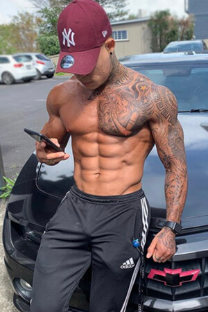 tanned friendly looking topless waiter with big smile and awesome body